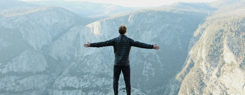 A Man Standing on A Mountain